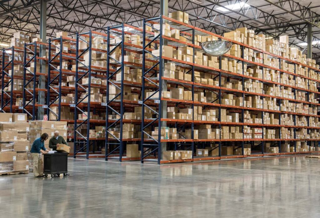 two employees checking inventory in warehouse